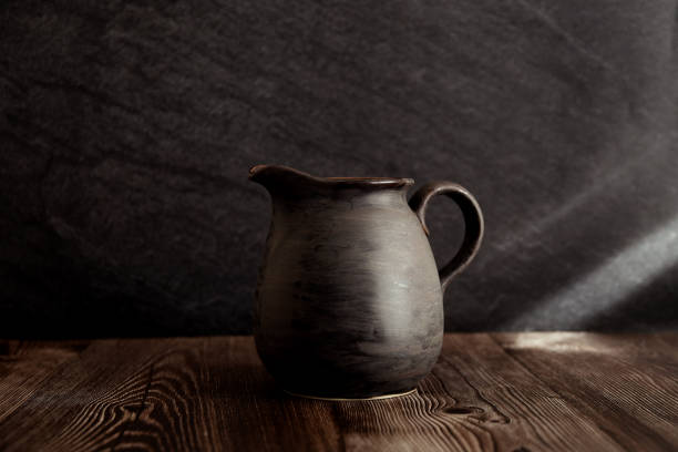 istock The photograph shows a minimalist still life with a ceramic jug. 2201107207