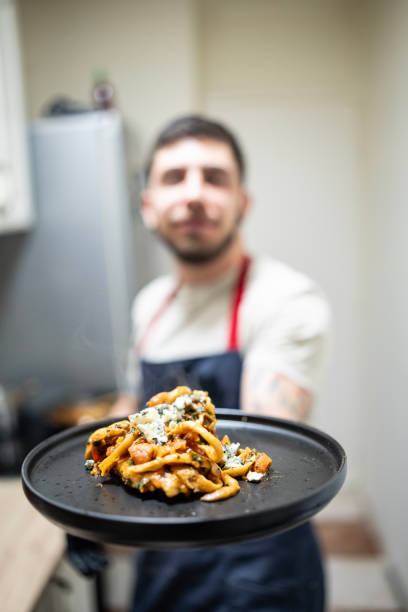 istock Chef Presenting a Plated Italian Dish in a Home Kitchen Setting 2201109592