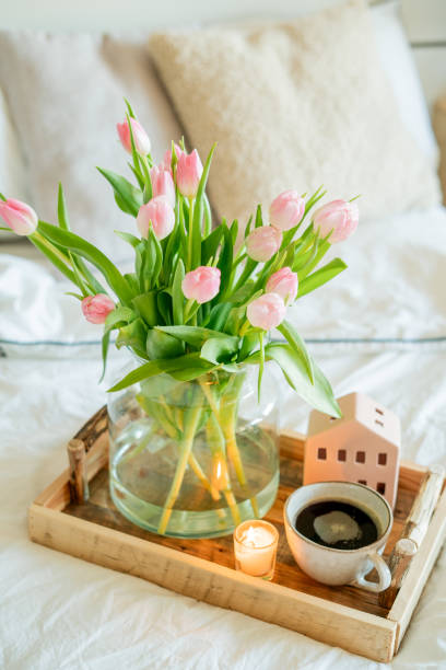 istock Home spring decor, bouquet of tulips in vase, hot coffee. 2201109655
