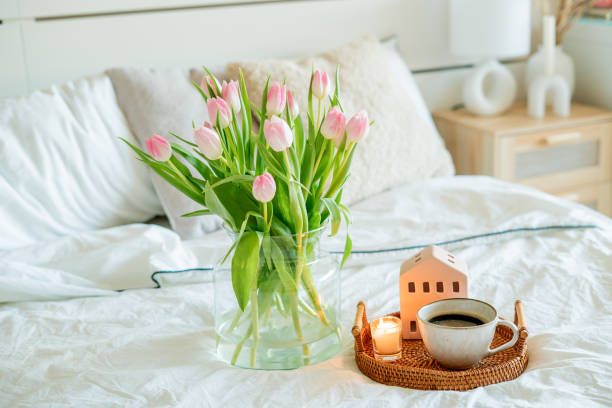 istock Home spring decor, bouquet of tulips in vase, hot coffee. 2201109656