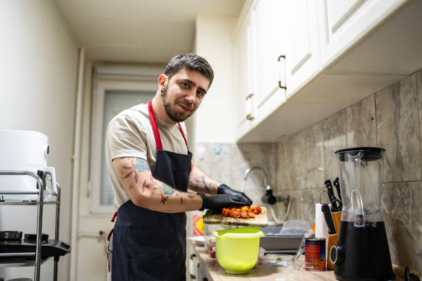 istock Man Preparing Fresh Ingredients in a Home Kitchen Wearing Apron 2201109657
