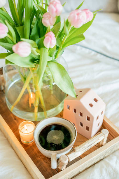 istock Home spring decor, bouquet of tulips in vase, hot coffee. 2201109721