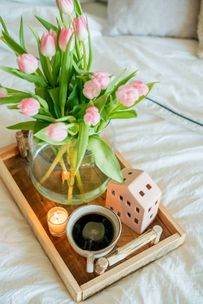 istock Home spring decor, bouquet of tulips in vase, hot coffee. 2201109794