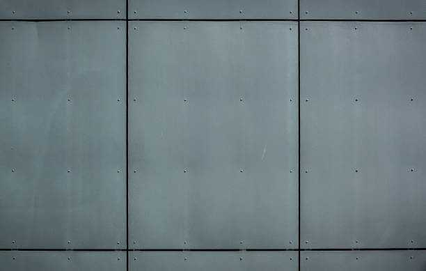 Industrial gray wall with sleek metal panels reflecting modern architectural style