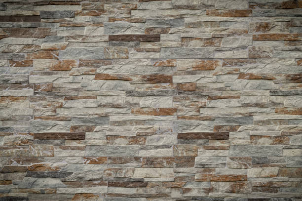Elegantly textured stone wall showcasing earthy hues and natural patterns in serene indoor ambiance