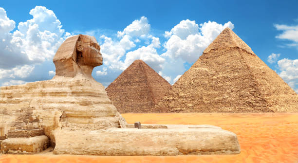 istock Famous Great Sphinx and pyramids of Chephren, Cheops, Menkaure, Cairo, Egypt. Great Pyramids and statue of Sphinx, mythical creature with head of man and body of lion, Giza complex (Giza Necropolis) 2201111943