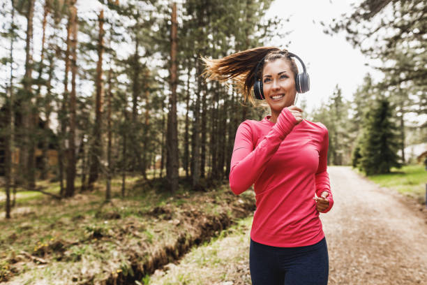istock Woman Running In The Forest 2201112843