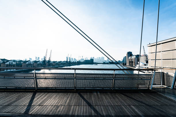 Scenic view of london's skyline from a modern cable-stayed bridge over the river thames
