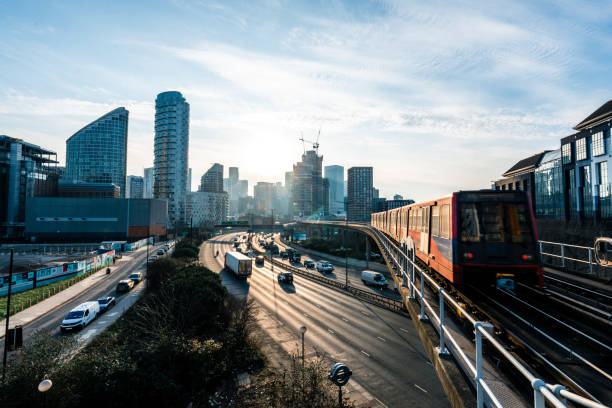 istock Docklands light railway passing by london's modern buildings at sunset 2201113710