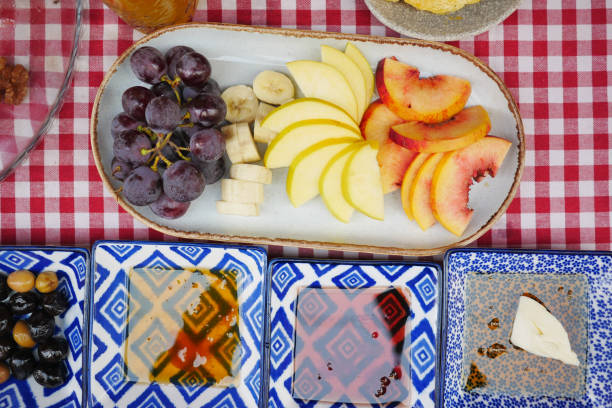 A beautiful assortment of fresh fruits with dips, nicely arranged on a picnic table