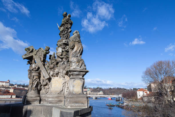 Stone and bronze sculptural monument of saints and angels in Prague, on the Charles Bridge, on the banks of the Vltava River