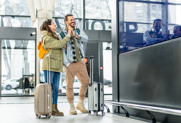 istock Couple in front of the information board at a train station 2201121752