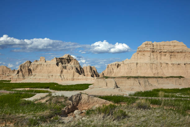 istock Rugged Badlands Landscape at Door Trailhead with Blue Sky and Clouds 2201122141