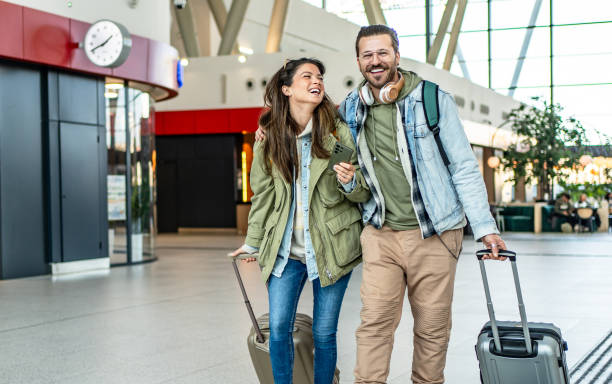 istock Husband and wife passengers at the train station 2201122213
