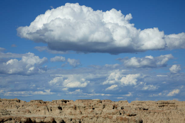 istock Rugged Badlands Landscape at Door Trailhead with Blue Sky and Clouds 2201122303