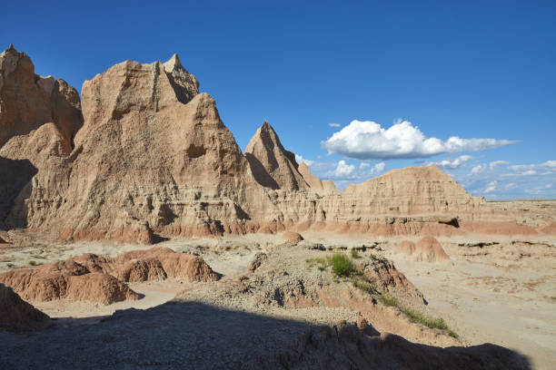 istock Rugged Badlands Landscape at Door Trailhead with Blue Sky and Clouds 2201122461