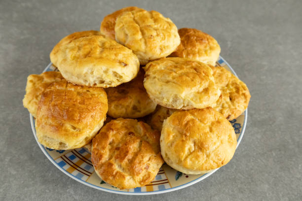 istock Homemade golden brown scones on a plate on a gray surface. 2201122537