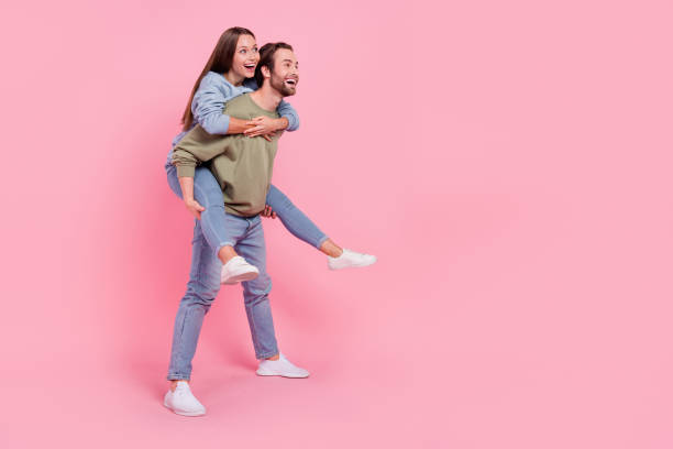 istock Full size profile photo of attractive lady handsome guy piggyback look empty space isolated on pink color background 2201123797