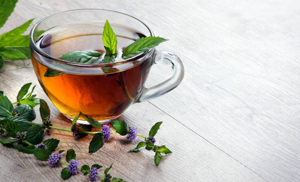 istock cup of mint tea on a wooden table. herbal tea. copy space 2201124108