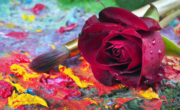 beautiful red rose and brush on artist's palette