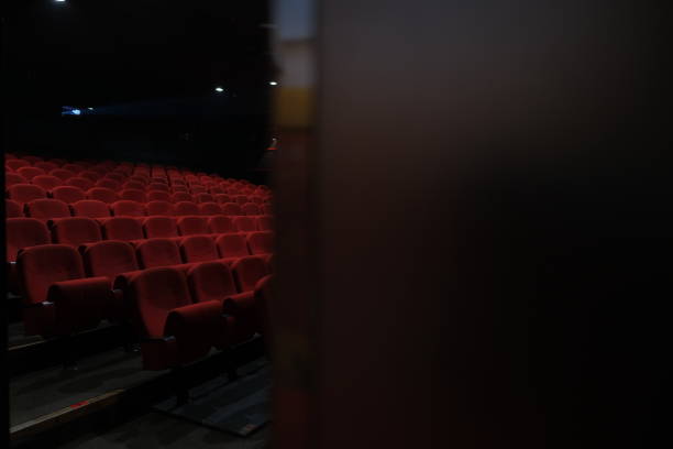 istock Rows of empty red theater seats offer a glimpse into a darkened auditorium awaiting audience and showtime 2201138873