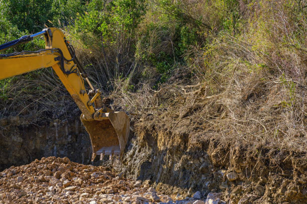 Excavation work. Excavator bucket during road construction in the mountains. Montenegro, Dinaric Alps