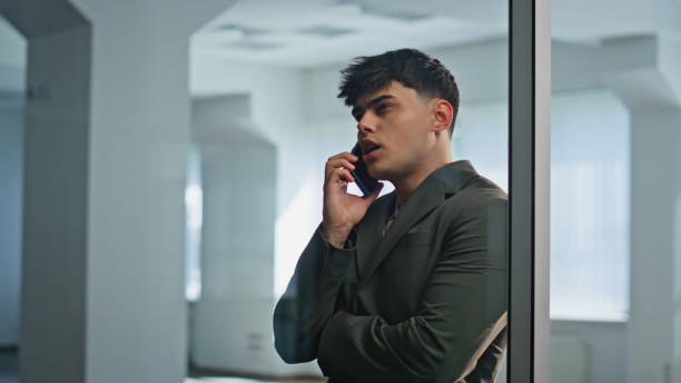 istock Manager negotiating cellphone call inside office building meeting room closeup 2201145408