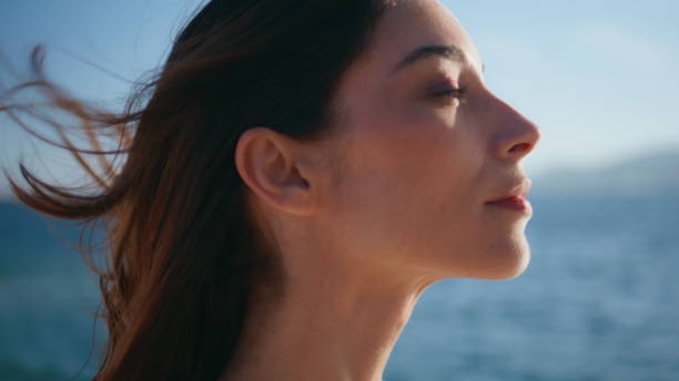 istock Closeup vacation woman face illuminated summer sunlight on tropical beach. 2201153475