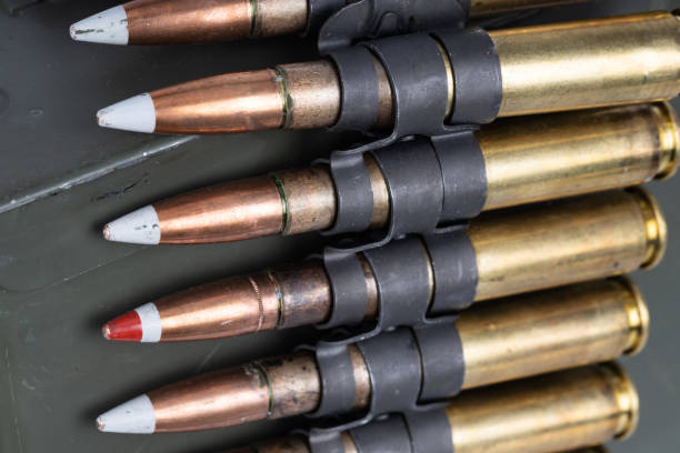 istock .50 BMG caliber machine gun ammunition belt with cartridges in ammunition can. 2201153592