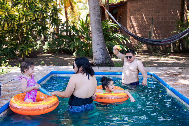 istock Tropical Swimming Pool Time with Kids and Aunt and Uncle 2201154492
