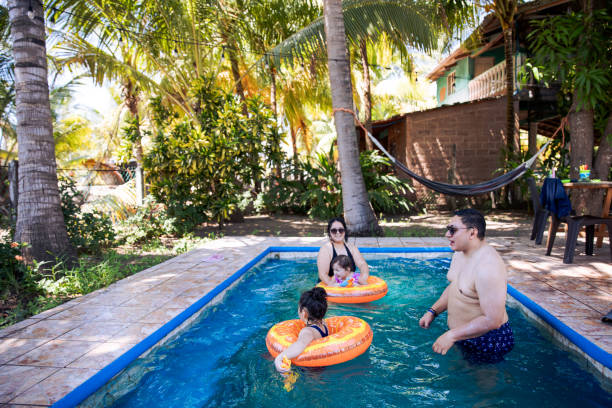 istock Tropical Swimming Pool Time with Kids and Aunt and Uncle 2201154493