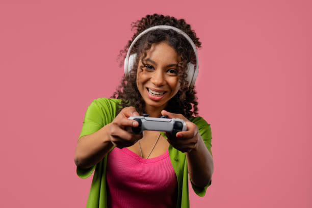 istock Young african woman playing and win online video game on console with joystick 2201156245