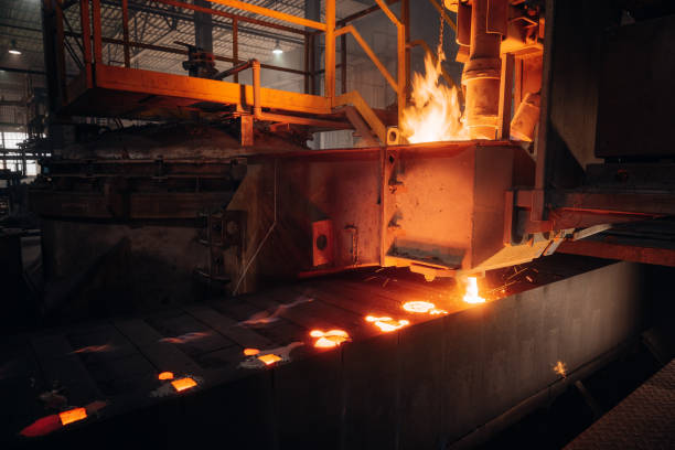 istock Molten metal pouring into casting molds in a foundry 2201157578