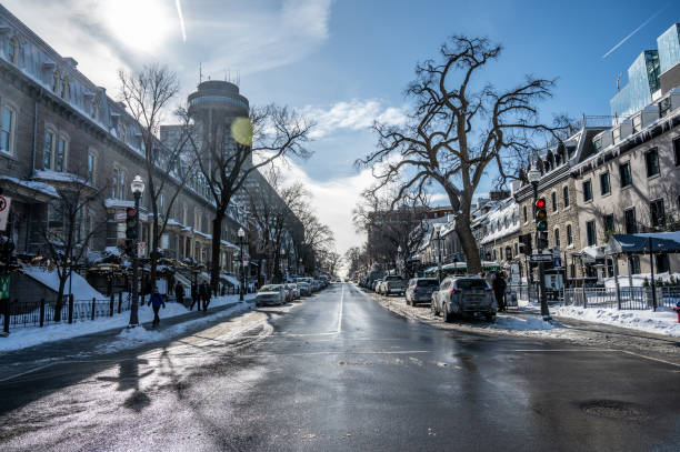 Main Street (Grande-Allée) downtown Quebec city during winter day with the famous turning restaurant  on top of Le Concorde Hotel.