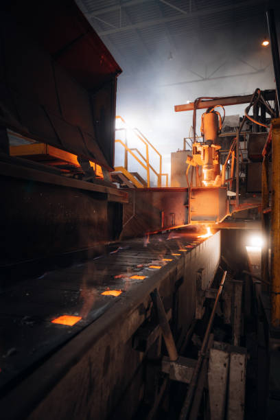 istock Molten metal flows along a conveyor belt in a metal foundry 2201157943