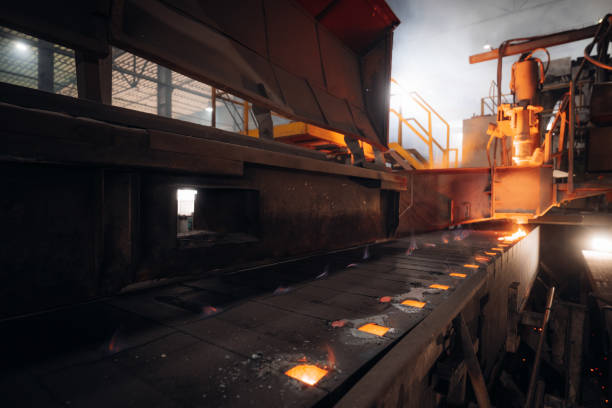 istock Molten metal flows along a conveyor in an industrial setting 2201157944