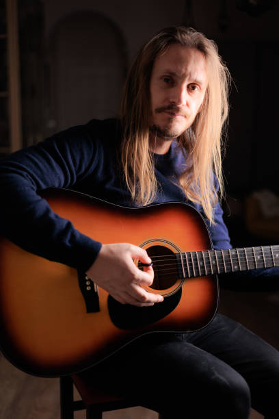 istock Musician playing acoustic guitar 2201162337