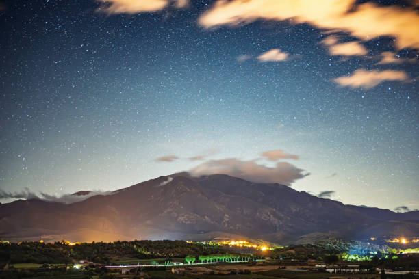 Night view of illuminated cityscape with Mt. Fuji in the distance