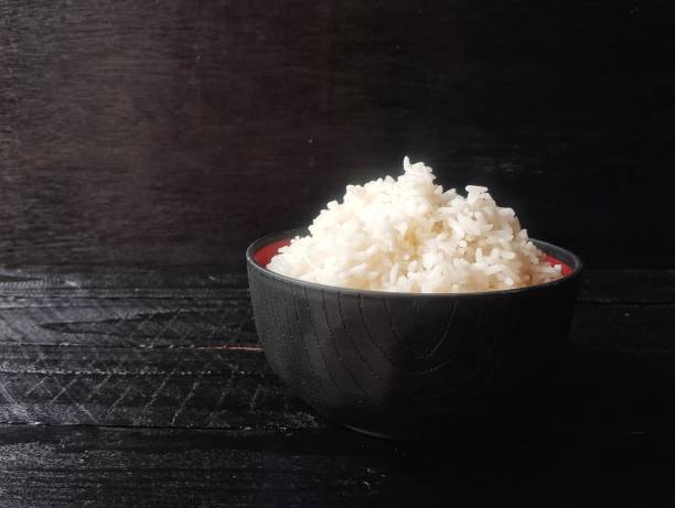 istock Nasi putih or white rice in bowl on black wooden table background 2201174246