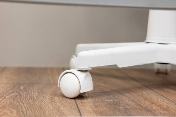 istock Rolling chair wheels on a wooden floor in an office setting during daylight hours 2201175926