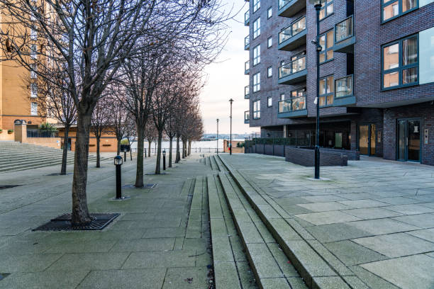 istock Empty urban square with bare trees and a modern residential building in the background 2201179287