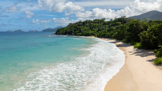 istock Tropical waves crashing on a sandy beach. Seychelles, Mahe. 2201182159