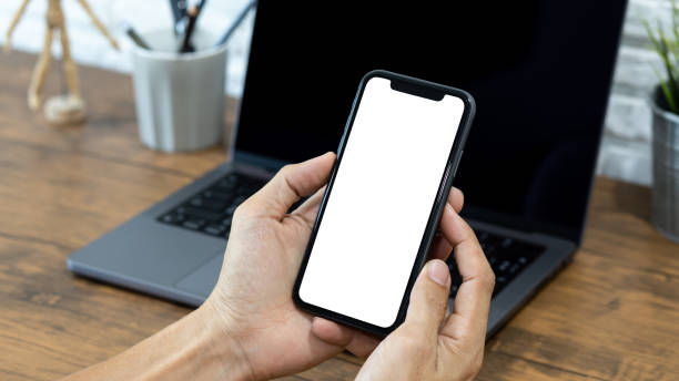 istock Hands of a businessman using a  smartphone mockup at his desk, Mobile phone blank screen for editing graphics. 2201185942