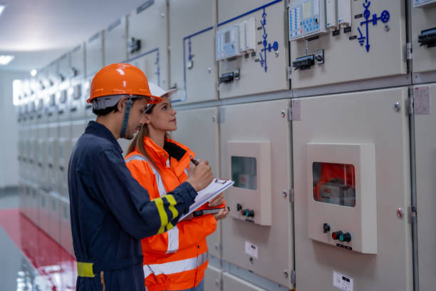 istock Efficient teamwork in control room with man and woman inspecting electrical panels. focus is on safety and precision in professional environment 2201193938