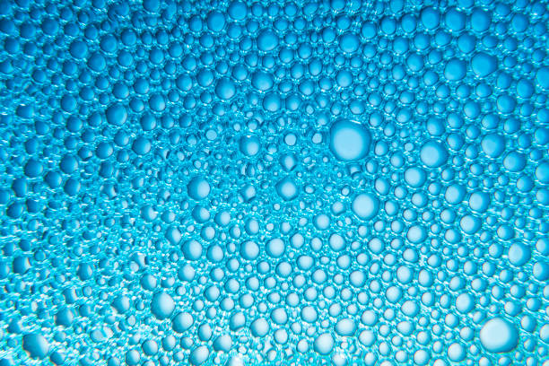 Texture of soap bubbles and water with blue light