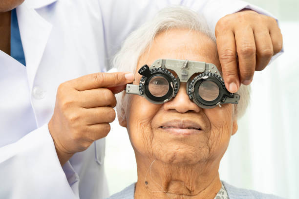 istock Asian senior woman wearing ophthalmic vision eye test and using optical trial frame. 2201201624