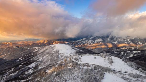 istock Aerial view of snow-covered mountains at sunset. 2201206718