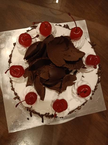 istock Black forest cake topped with whipped cream and cherries . dessert. cake. home made cake 2201207689