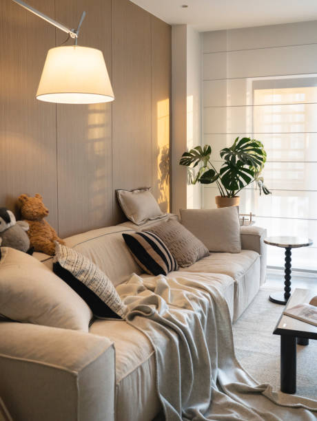 istock Comfortable living room space with comfortable sofas, carpets, pillows and sunshine 2201211061