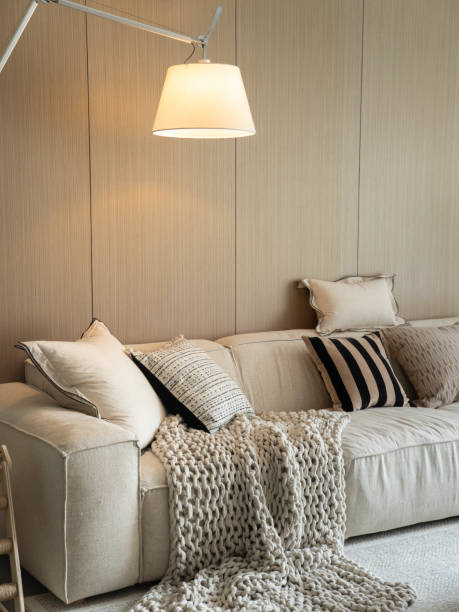 istock Comfortable living room space with comfortable sofas, carpets, pillows and sunshine 2201211524